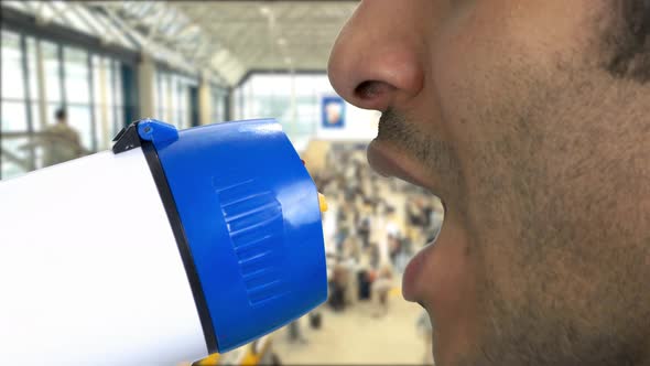 Extreme Closeup Brownskinned Man Talking in Megaphone alt