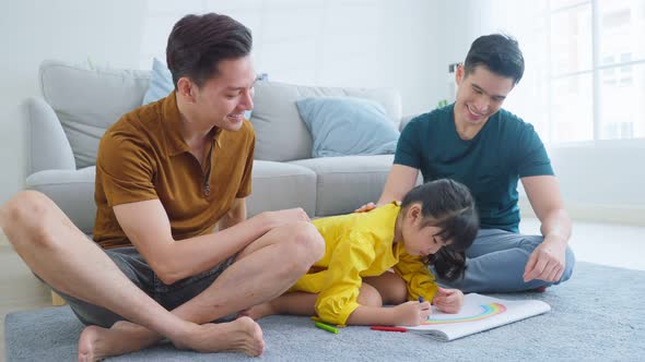 Asian attractive LGBTQ gay family teach young girl kid draw picture and coloring book in living room alt