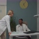 Young Adult Male Therapist Arguing with Mature Female Doctor Indoors - VideoHive Item for Sale