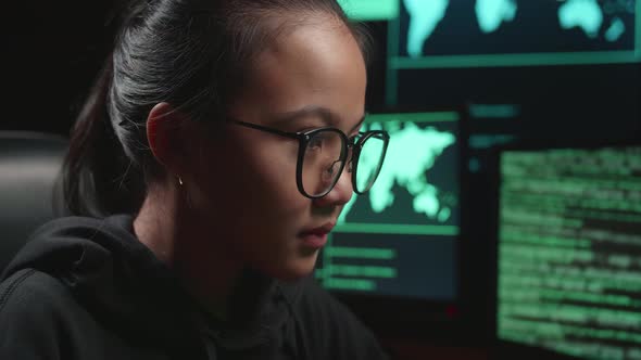 Asian Young Girl Hacker Hacking With Multiple Computer Screens In Dark Room alt