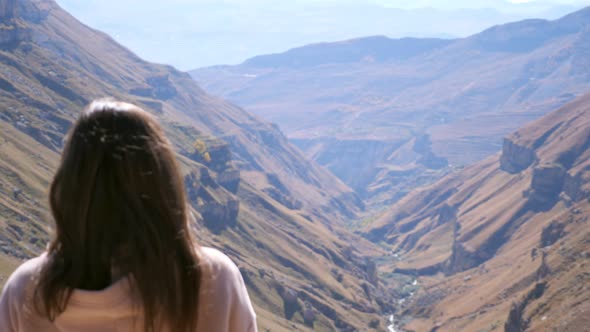 Lady in Pink Hoodie Comes to Enjoy Picturesque Highland View alt