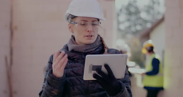 Confident Young Female Building Contractor on Video Call alt
