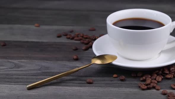White Cup with Black Coffee on a Dark Wooden Background