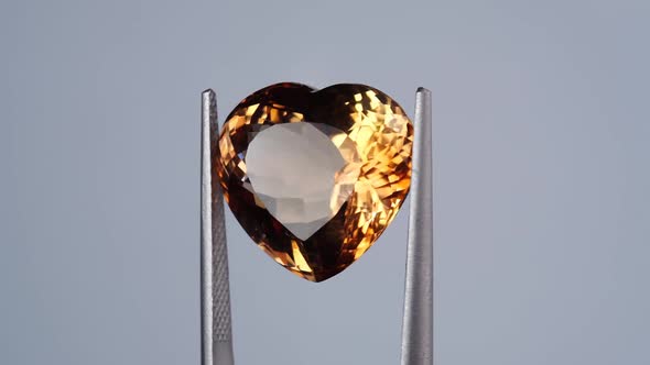 Imperial Champagne Yellow Topaz Heart Cut in the Turning Tweezers