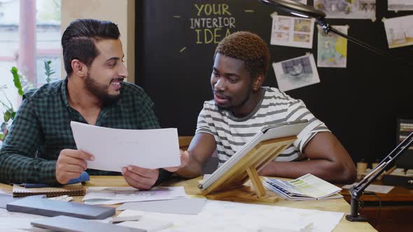 Multiethnic Male Designers Discussing Project 