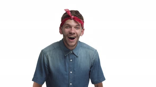 Video of Happy Handsome Bearded Man Wearing Red Headband Looking at Something with Surprised Face