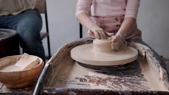 Little Girl with Manufacture Master Making Earthenware Objects