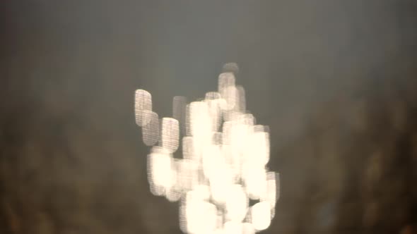 Anamorphic Bokeh On Water. Anamorphic Light.Anamorphic Bokeh Blinking On Water. Anamorphic Lens Shot alt