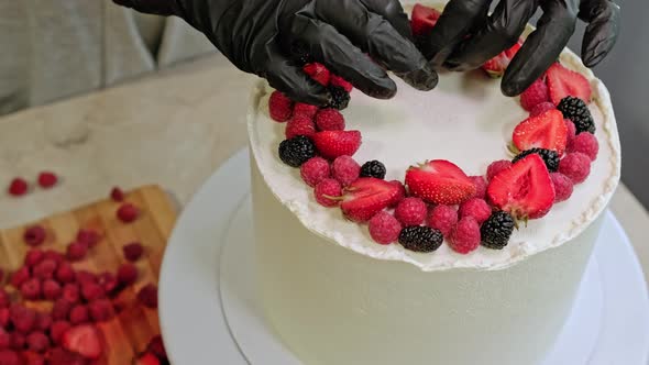 Pastry Chef Woman Making Cake Fresh Berries on Rotating Table