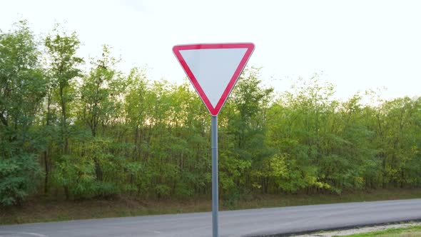 Give Way Yield Road Traffic Sign and Truck in the Background alt