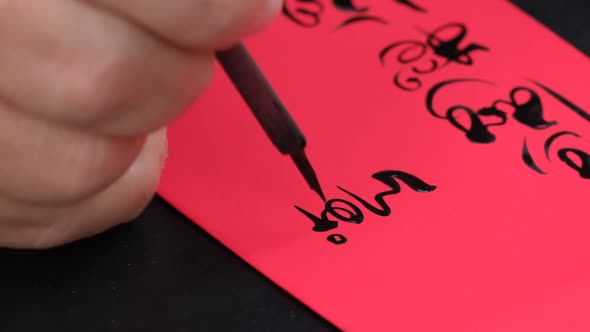 Vietnamese scholar writing calligraphy at the lunar new year