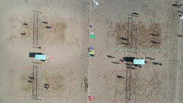Top View of a Group of Friends Playing Beach Volleyball on the Beach