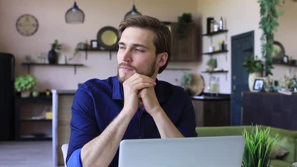 Worried, thoughtful, serious entrepreneur man working on laptop at home office alt