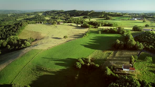 Aerial View Of Rolling Hills And Straw Bales In Field In Correze 