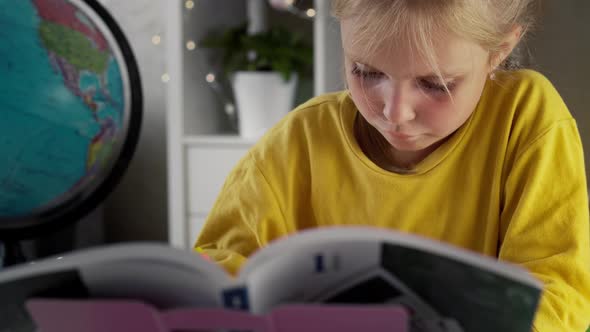 Blonde Girl with Textbook and Globe