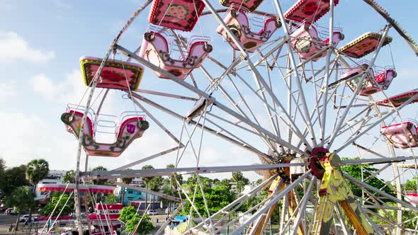 Classic ferris wheel, amusement park on pier in Santo Domingo. Summertime, iconic view.