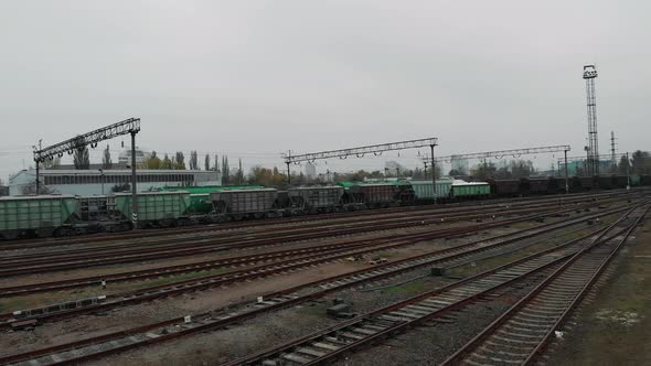 Aerial view of long freight cargo train with wagons and fuel tanks alt