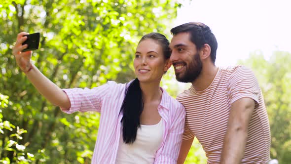 Couple with Bicycles Taking Selfie By Smartphone alt