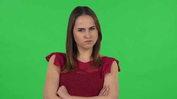 Portrait of Tender Girl in Red Dress Is Very Offended and Looking Away. Green Screen alt