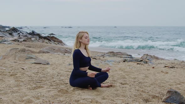 Woman Is Trying to Relax and Meditate On Beach