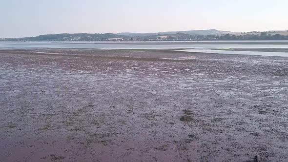 Slow tilt up of The Ridge and River Exe, Lympstone. Aerial footage. alt