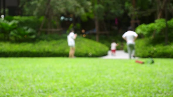 Happy Family Mom Dad and Kid Walks Leave Public Park After Play Together