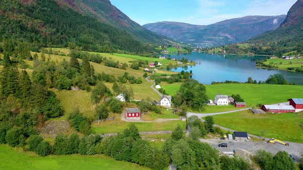 stunning valley with homes surrounded by mountains and a lake