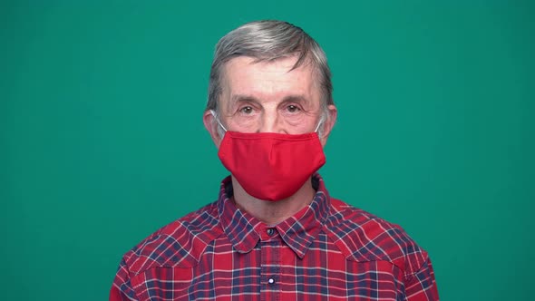 Portrait of Mature Man in Protective Red Medical Face Mask alt