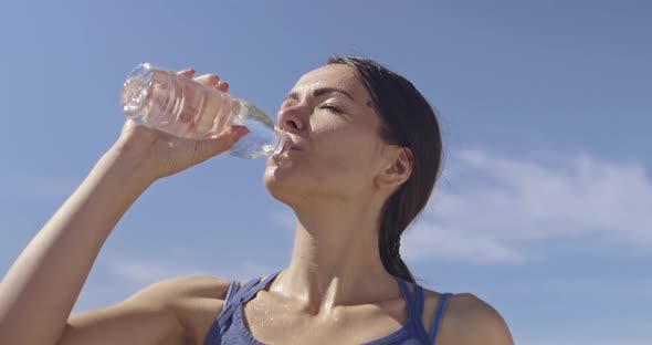 Slow Motion Shot of Sporty Trail Running Woman While Drinking Water and Resting From Intense Jogging alt