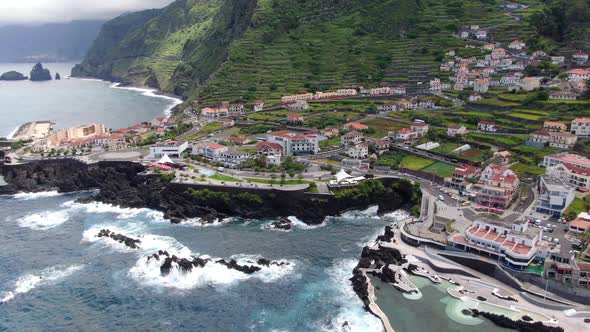 Flying over Porto Moniz town in northern Maderia, Portugal alt