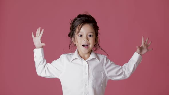 Cute Little Child Girl in White Shirt Shows Different Emotions on Pink Background