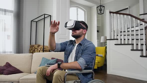 Bearded Guy in Wheelchair Working on Virtual Screen Using Special 3d Glasses alt
