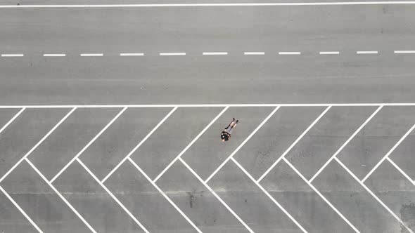 One man lying on parking area on road alt