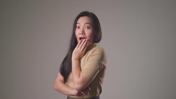 Confident asian woman happy standing smilling and looking at camera standing over background.