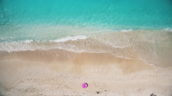 Aerial View of the Pink Swim Ring on the Sandy Beach Near Sea