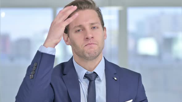 Portrait of Shocked Young Businessman Reacting To Failure alt