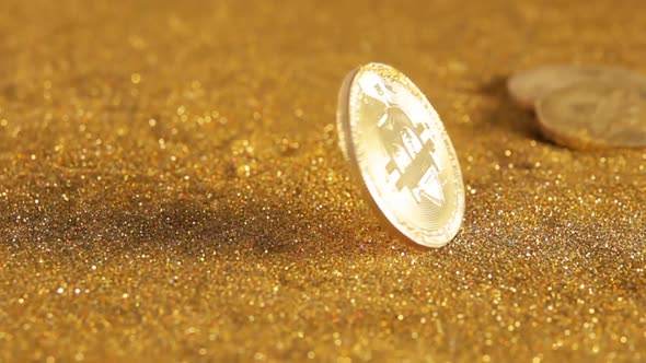 Bitcoin Spins on a Table With Golden Sand