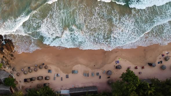Aerial over idyllic Sri Lanka Beach. Palm trees and waves on sand beach. Tangalle, Sri Lanka alt