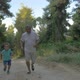 Grandfather and grandson jogging in the forest - VideoHive Item for Sale