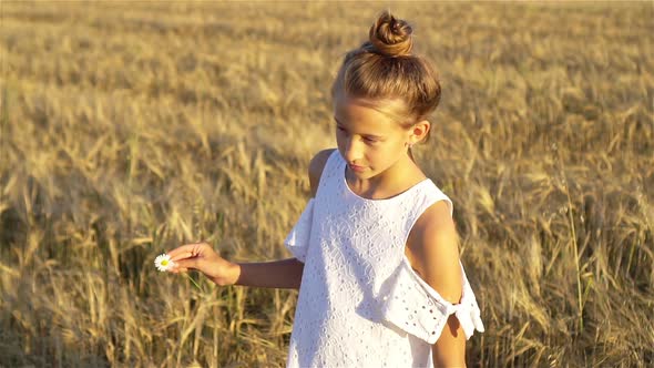 Happy Cute Girl in Wheat Field Outdoors