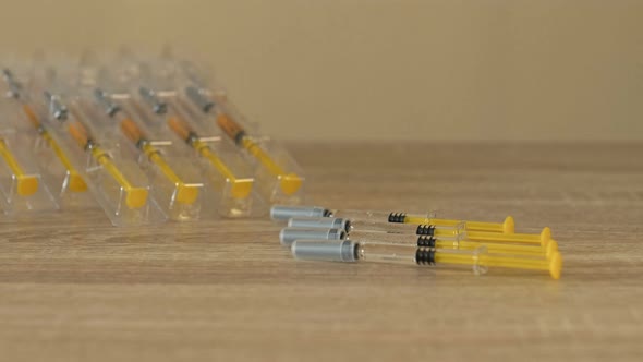 Nurse's Hands Preparing a Syringe for Injection or Vaccination alt