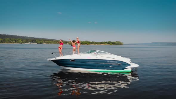 Aerial View Three Beautiful Women Dancing They Had a Party on a Motor Yacht alt