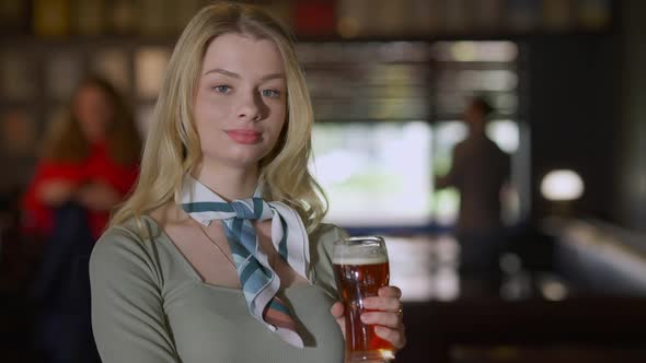 Confident Gorgeous Young Woman Posing with Beer Glass in Pub Indoors alt