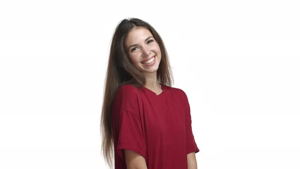 Video of Pretty Brunette Girl in Red Casual Tshirt Looking Coquettish and Happy Smiling Delighted alt