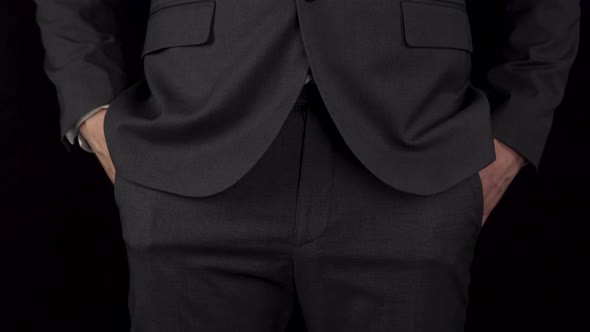 A Young Businessman in a Suit Pulls Out a Condom From His Pocket and Holds It in His Hand alt