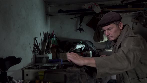A Man Works in an Old Home Workshop alt