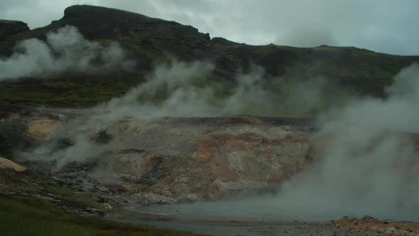 dramatic iceland landscape, geothermal hot spring pool steam smoke rising, beautiful relaxing nature