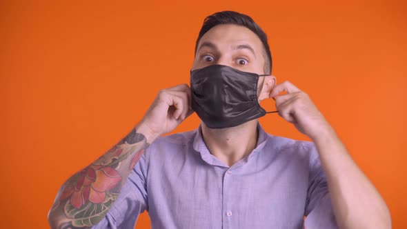Man Takes Off Black Medical Mask, Takes Deep Breath. Fight Against Virus. Stop Quarantine alt