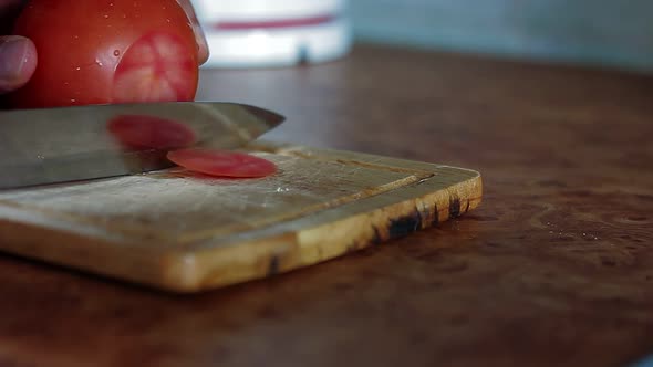 Slicing a Fresh Ripe Tomato to a Slices Vegetable Food Preparing Concept
