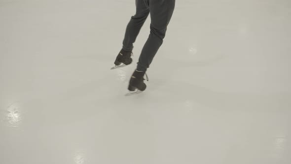 Legs of a Skater Rolling on Ice